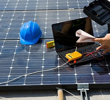 Solar technician installing or inspecting solar panel system using tools.