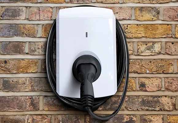 A house with a charging plug, a charging station.