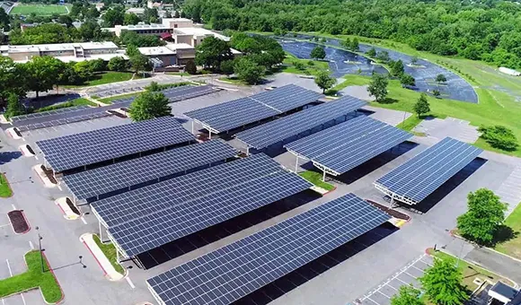 Aerial view of a large complex with extensive rooftop solar panel arrays.