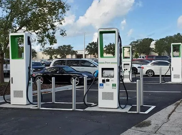 Outdoor level 2 electric vehicle charging stations installed at a commercial parking area with several EVs parked.