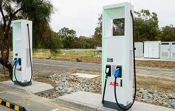 Multiple electric vehicle charging stations installed in an outdoor setting, with a clear view of the charging units and surrounding area.