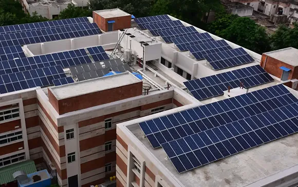 Aerial view of a large residential or commercial building complex with solar panels installed on rooftop and surrounding areas, symbolizing solar panel upgrade financing in Amarillo, TX.